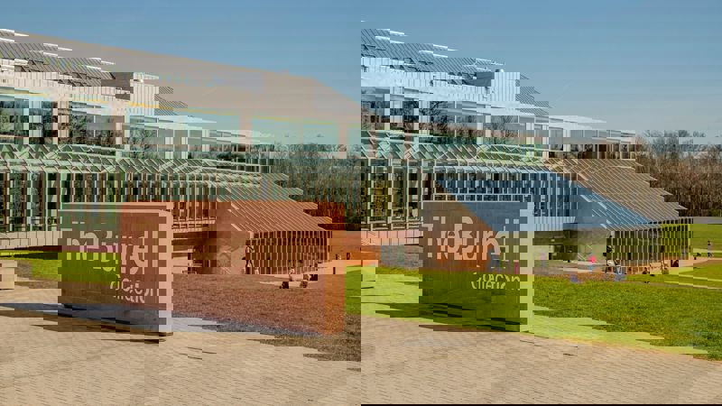 An outdoor sign reads "The Burrell Collection" in front of a modern building.