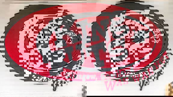 A red and white sign for "King Tut's Wah Wah Hut" is mounted on a building.