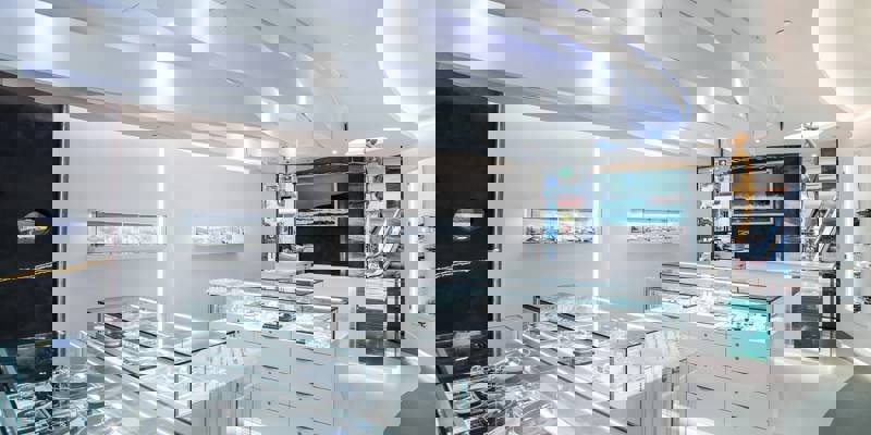 The clean, modern interior of a jewellery store with bright lighting and a white, curved ceiling.