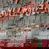 Singer Eddi Reader waves from a red City Sightseeing bus in front of the iconic Barrowland Ballroom sign.