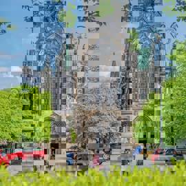 Glasgow Cathedral and the statue of David Livingstone surrounded by greenery. 