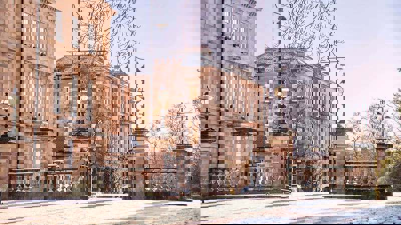 Elegant sandstone townhouses at Park Circus in Glasgow on a bright winter day with light snow.