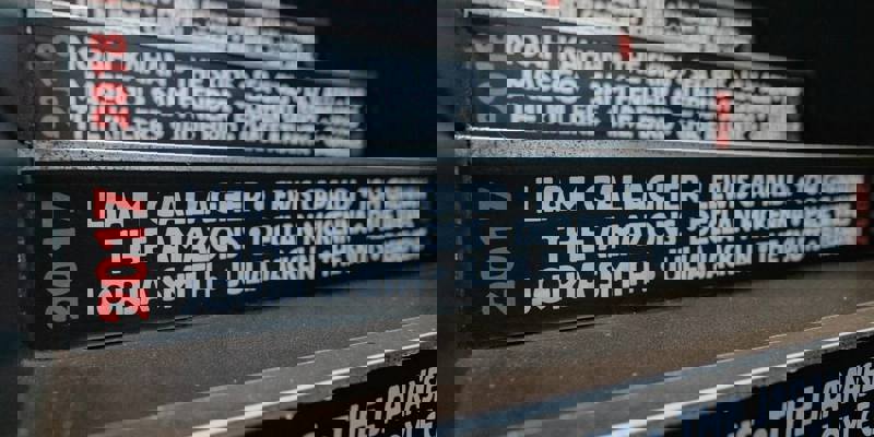 A close-up view of a staircase with the names of musicians who performed there, including Liam Gallagher and Lewis Capaldi.