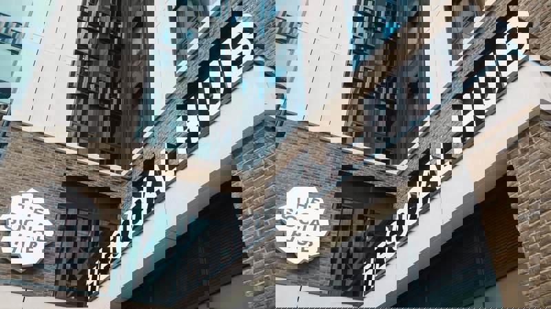 Exterior of The Social Hub Glasgow showing its modern brick and glass façade with large signage above the entrance.